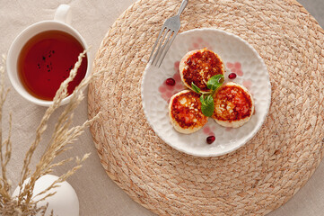 Fragrant fried tvorog pancakes with mint and pomegranate for the perfect breakfast.