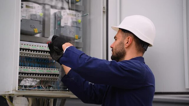 Electrician fixing electrical panel wiring outdoors