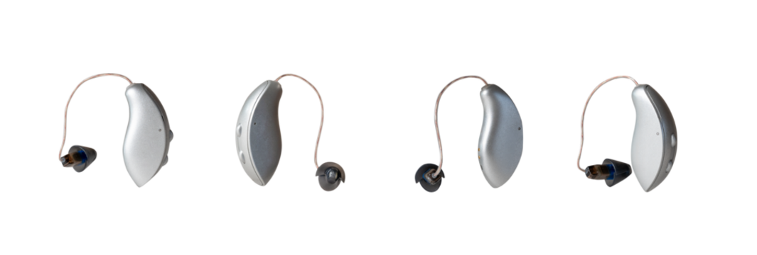 Four modern hearing aid devices displayed on a white background, showcasing various angles and placements