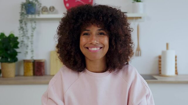 POV happy young woman listening colleague on laptop video call working from the kitchen at home. Young freelancer female talking with partner through online meeting. Business and teleworking concept
