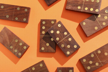 Wooden dominos blocks on orange background