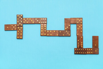 Wooden dominos blocks on blue background