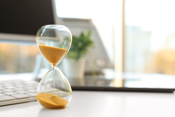 Hourglass on desk in office, closeup