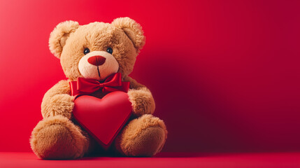 Obraz premium Teddy bear with a red heart on a background with space for text or design