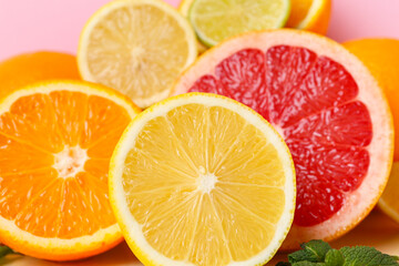 Different cut citrus fruits, closeup