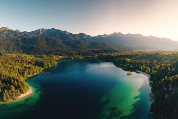 Obraz premium Panoramic aerial view of serene lake nestled in mountains at sunset.