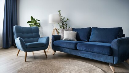 Dark blue sofa and recliner chair in scandinavian apartment. Interior design of modern livin 