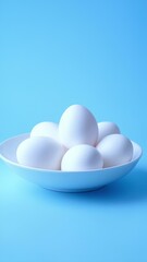  White chicken eggs in white bowl with detailed shell texture on light blue background with space for text. Background for design, advertising.