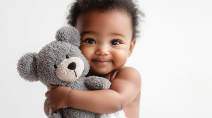 Adorable baby embracing a plush toy with joyful expression