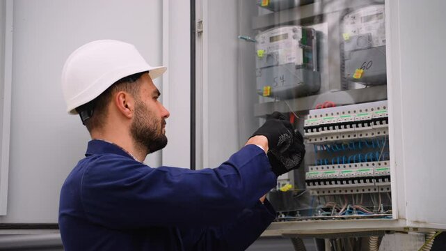 Electrician working on electrical panel wiring
