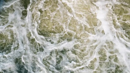 An Aerial View of the Turbulent and Chaotic Ocean Waves from Above a Scenic Coastline