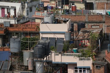 Scenery of roofs of buildings in Kathmandu with water tanks and solar panels, Nepal