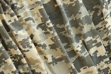 Texture of Dark green pixel camouflage military uniform textile cloth with folds
