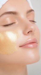 Close up of a woman's face with a gold glitter face mask, eyes closed, serene expression, soft lighting, neutral background.