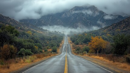 Misty Mountain Road Winding Upward Through Valley