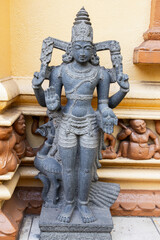 Ancient stone statue stands at the entrance of Gangaramaya Temple