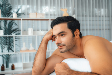 Caucasian man customer enjoying relaxing anti-stress spa massage and pampering with beauty skin...