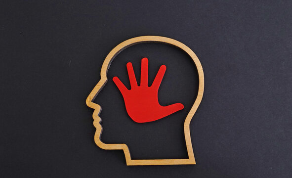 Head outline and a stop hand sign. Mental boundaries and self-protection.