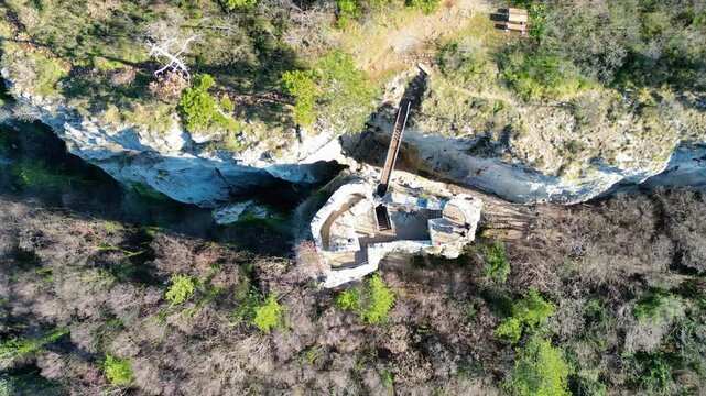 A stunning aerial drone view of Črni Kal, Slovenia, featuring the historic Castle of San Sergio atop a hill and the modern Črni Kal Viaduct, part of the A1 motorway (toll road), spanning Vipava Valley