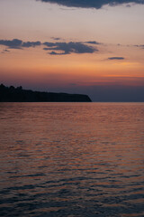 Sunset with rich colours over sea and Greek coastline