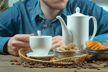 Coffee beans in the hands of an elderly man. Close-up.