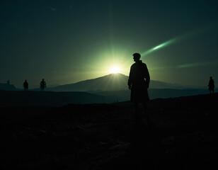 Fototapeta premium Silhouette of a person standing on a hill against a bright sun, possibly AI generated.