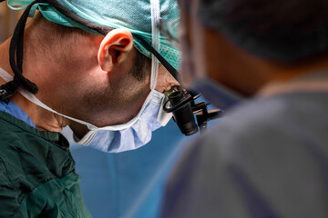 Surgeons wear magnifying glasses in the operating room. Intraoperative magnification using surgical...