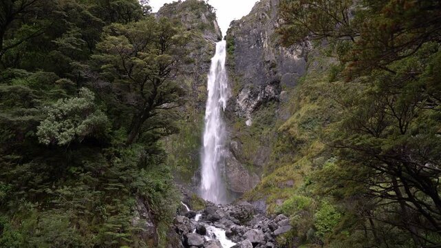 Devil&rsquo;s Punchbowl Waterfall in mountainous forest at Arthur&rsquo;s Pass, New Zealand