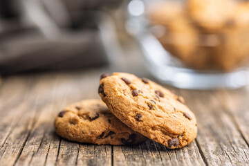 Chocolate chip cookies on wooden table.