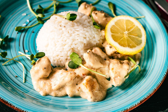 A French dish called fricassee. Tender chicken meat in a creamy sauce with rice, lemon and micro greens.