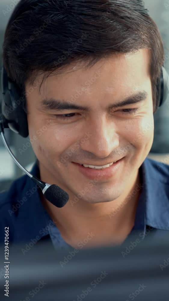 Aufkleber young competent asian male call center agent working at his computer while simultaneously speaking w