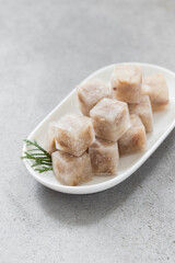 Aspic. Jellied meat in the shape of a mini cubes.