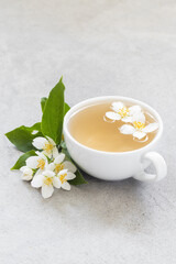 Tea with jasmine in a ceramic cup. Light gray background