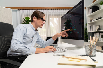 Fototapeta premium IT developer selecting by point on coding online software development information on pc comparing with laptop screen of new code program's update version firmware overall system project. Pecuniary.
