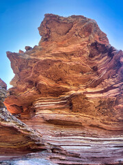 Layered Red Rock Formation Under Clear Blue Sky