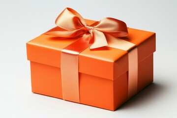Obraz premium Large orange box with a ribbon tied around it