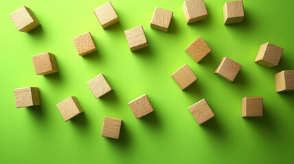 Scattered wooden blocks on green background
