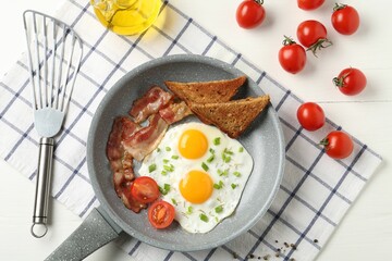 Tasty fried eggs with bacon and toasts served on white wooden table, flat lay