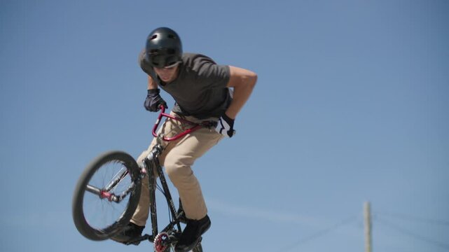 Slow motion 360 no hander BMX bike rider on ramp