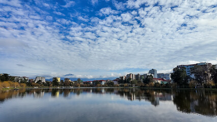 Fototapeta premium Lake in Batumi with a reflection of mountains and clouds.