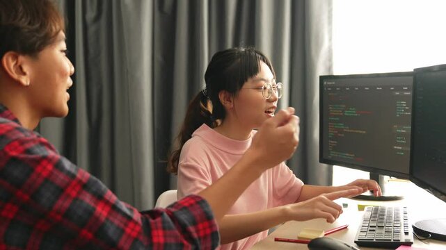 Slow motion back end software developer engineer for computer programming working together on debugging writing computing code, solving complex algorithms display on monitor in office. Burgeoning