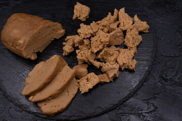 Seitan prepared at home out of wheat gluten and tapioca flour, sesame paste and spices, steamed. Copy space.