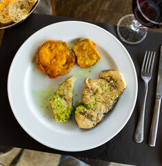 Delicious fried swordfish fillet served with breaded eggplant on plate