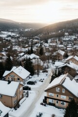 Fototapeta premium Snowy alpine village under a golden-pink sunrise creating cozy winter charm