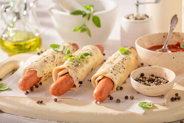 Unhealthy hot dogs baked in summer kitchen.
