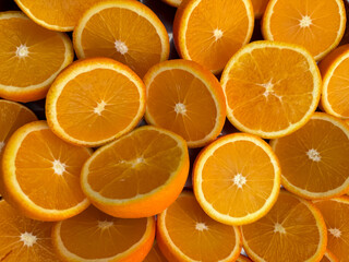 Many halved bright orange juicy oranges 