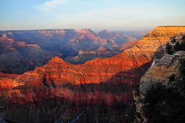 Grand Canyon's red and orange cliffs under a sunlit sky