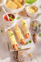 Delicious hot dogs served on a light table.