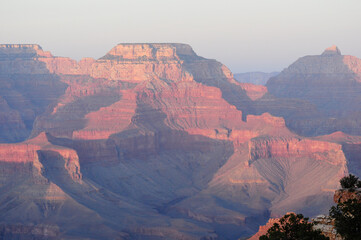 Grand Canyon's layered rocks at sunset with rich reds and oranges