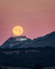 Sunset of the Moon over the castle of Archidona. Malaga. Spain.